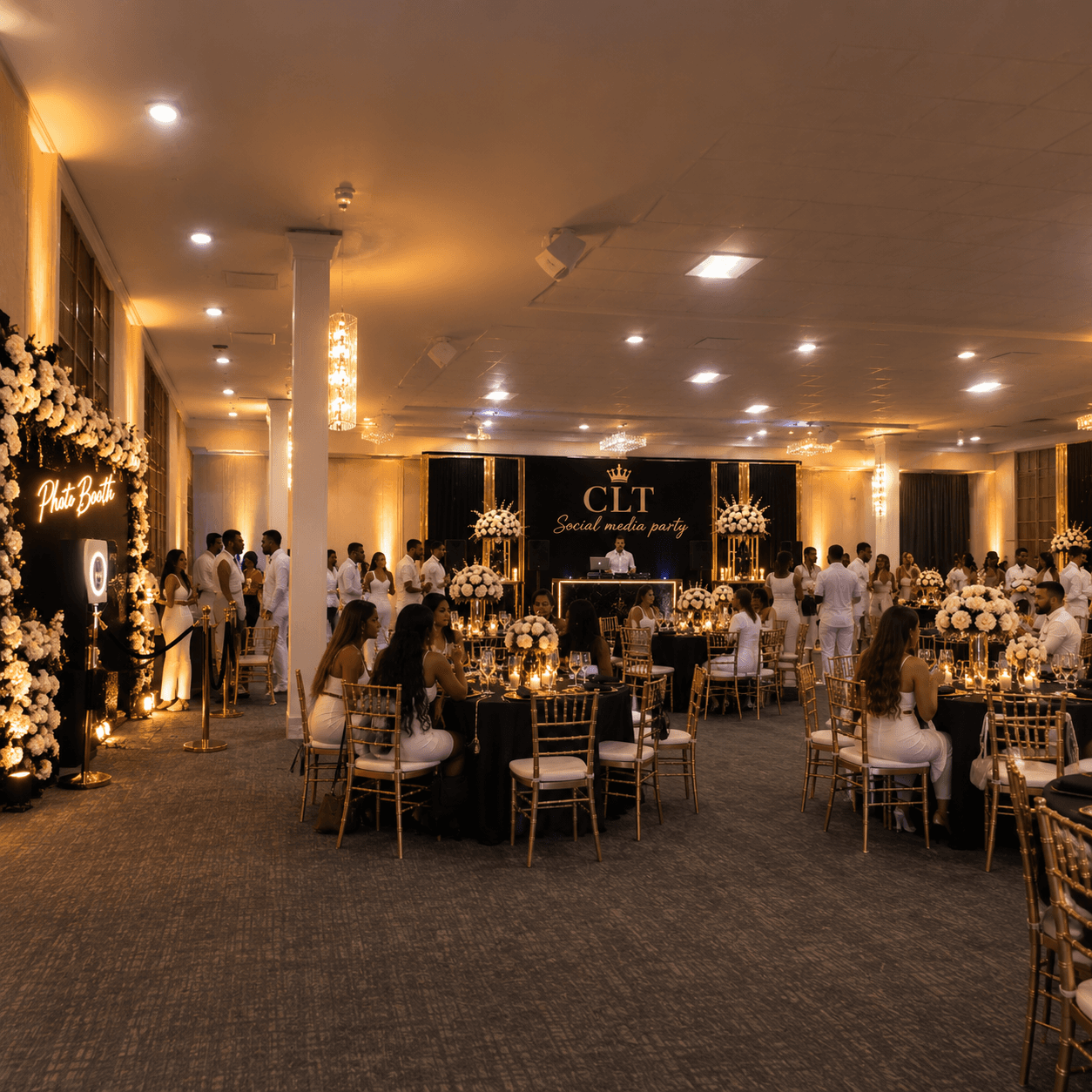 Guests in white attire attend a formal social media party in an elegant ballroom.