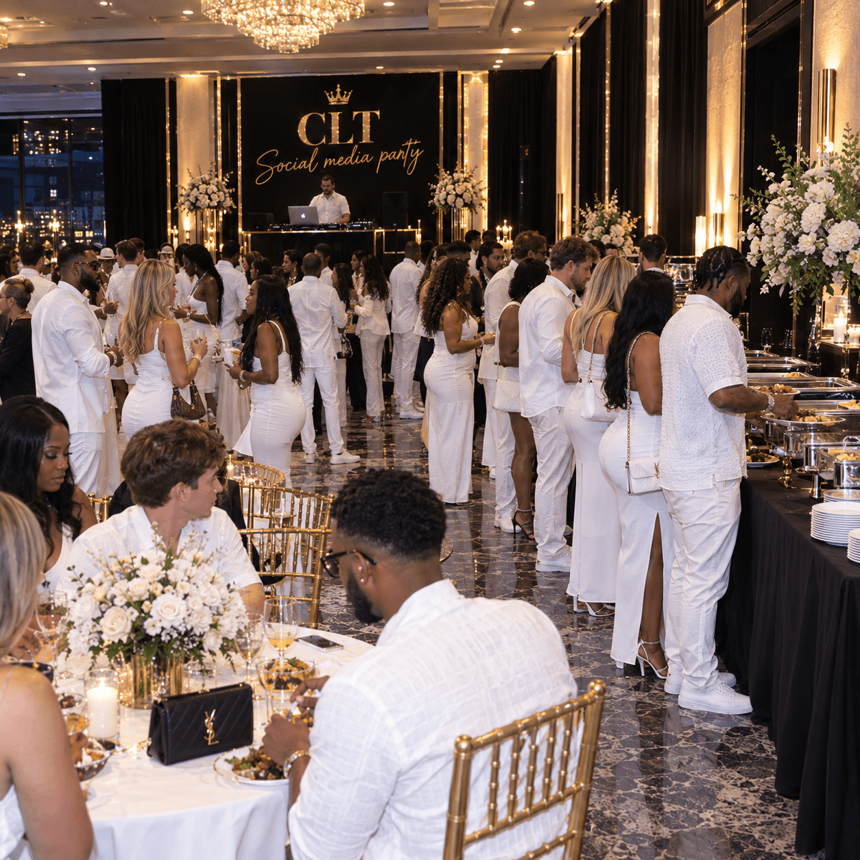 Guests in white outfits socialize at a glamorous social media party in an elegant ballroom.